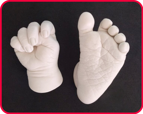 Framed 3D casting of a baby's hand and foot